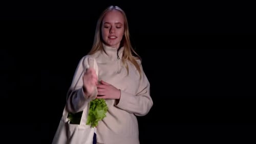 Smiling Young Woman with Lettuce in Studio
