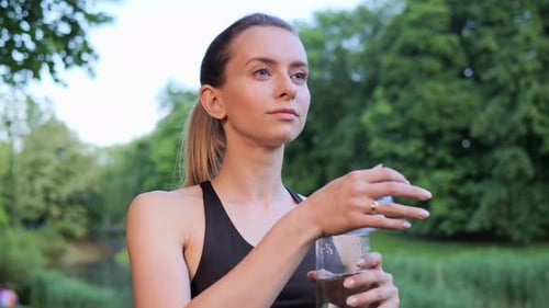 Woman Quenches Thirst After Workout Green Nature Background Drink Hydrating