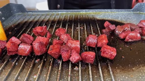 Diced Red Meat Cooking on a Grill