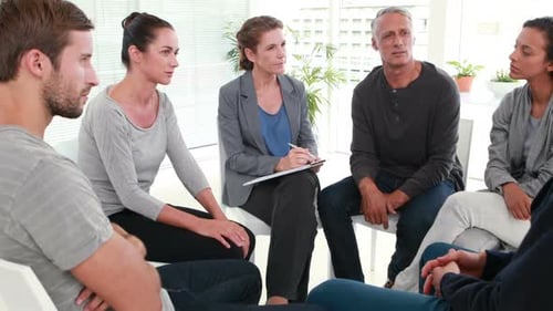 Group therapy in session sitting in a circle