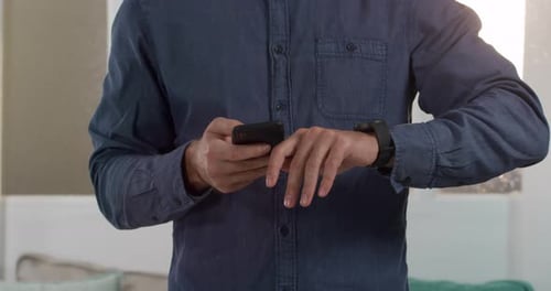 Person Interacting with Smartwatch and Smartphone Seamlessly