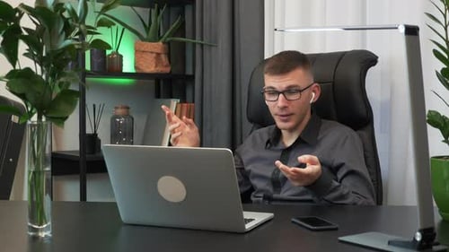 Man is talking on webcam on internet online meeting conference with colleagues