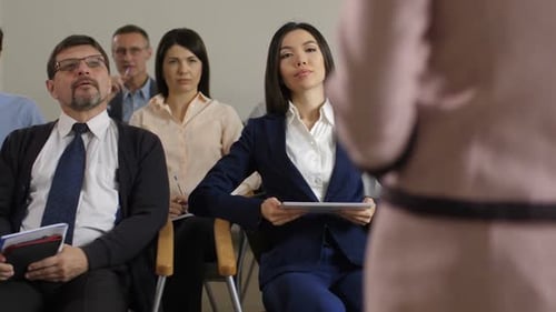 Diverse Group Attends Corporate Presentation at Workplace