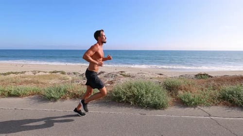 Athletic Man Exercising At The Beach
