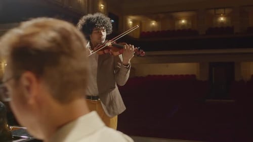 Musicians Playing Violin and Piano on Stage