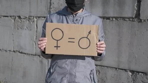 Woman Holding Gender Equality Sign in Urban Setting