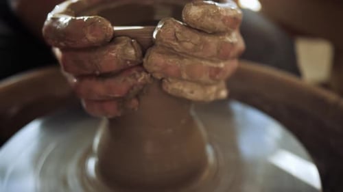 Hands Shaping Clay on Pottery Wheel