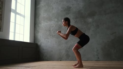 A Sportive Girl in Sportswear Shakes Her Muscles with an Elastic Band on Her Legs, Education