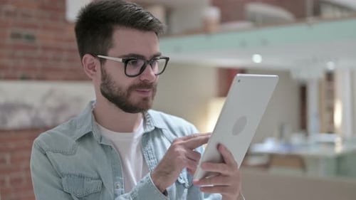 Man Uses Tablet Indoors