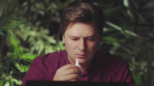 Adult Man Uses Nasal Spray for Relief