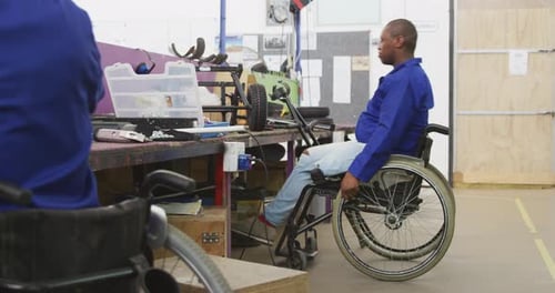 Adult Using Drill in Workshop after Wheelchair Transfer