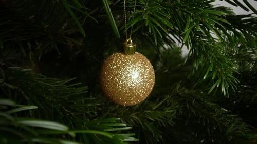Close Up of Gold Christmas Tree Ornaments