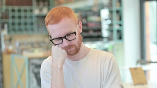 Portrait of Exhausted Redhead Man Taking Nap