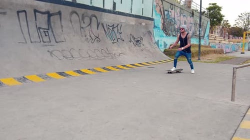Young boy using skate board in a street park