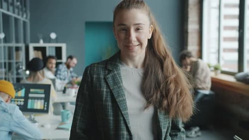 Beautiful Businesswoman Standing Indoors in Modern Shared Office Smiling Looking at Camera