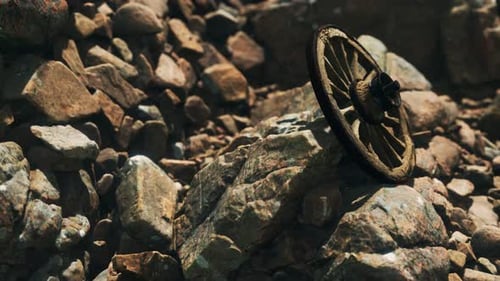 Old Wooden Wagon Wheel on Rocky Ground