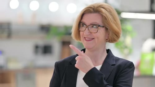 Portrait of Old Businesswoman Pointing at Something