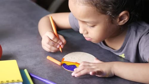Girl Drawing with Markers on Wooden Cutout Indoors