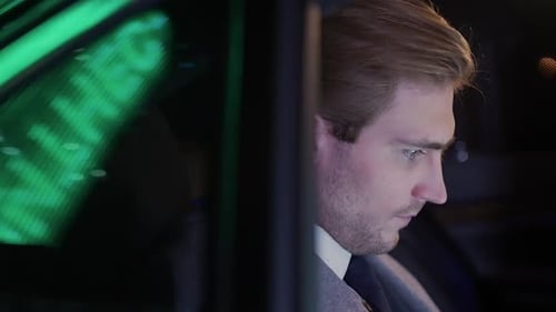 Businessman Sitting in a Moving Car and Drinks Coffee Man Top Manager in a Suit is Sitting in the