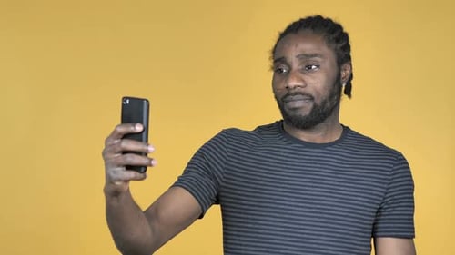 Young Adult Smiles While Taking Selfie With Mobile Phone