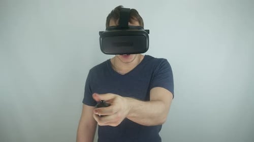 Young Man Using Virtual Reality Headset and Controller