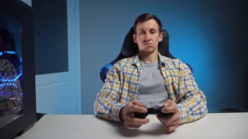 Adult Man Playing Video Game at Desk