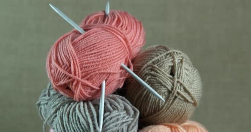 Colorful Yarn Balls with Knitting Needles in Basket