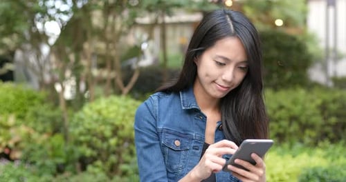 Woman Use of Smart Phone in The Park