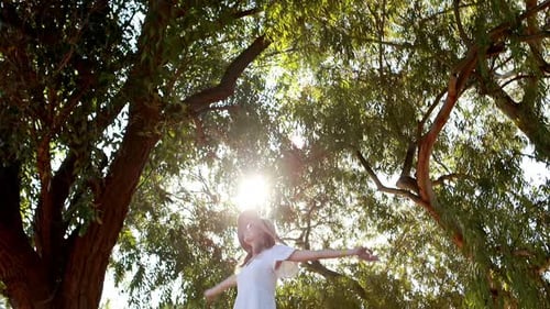 Happy Young Woman on Car Roof Outdoors