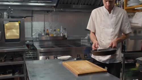 Chef Prepares Steak in Commercial Kitchen