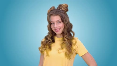 Smiling Woman Making Okay Sign on Blue Background