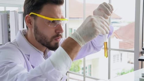 Man Working with Test Tubes in a Lab