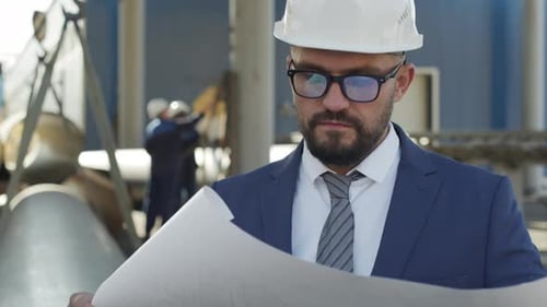 Professional Engineer Analyzing Blueprints at Construction Site