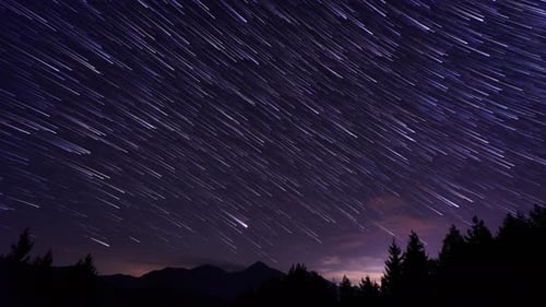 Star Trails Time Lapse Over Dark Mountain Landscape