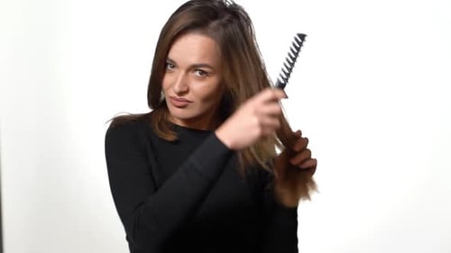 Brunette Woman Brushing Hair with Round Brush