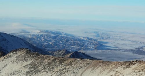 Aerial View of the Top of a Mountain Range in Winter