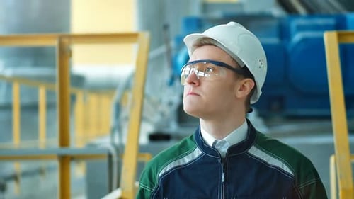 Engineer in Hardhat is Walking in Heavy Industry Factory