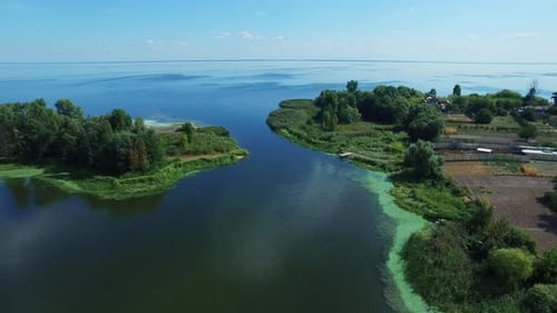 Drone View Island and Farming Field on Shore. Blue Sea on Clear Horizon View