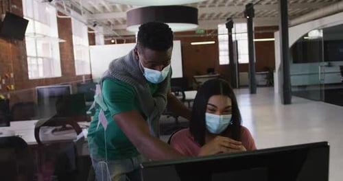 Coworkers Working Safely in Modern Office with Masks