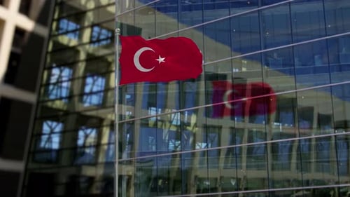 Realistic Turkish Flag Waving on Pole in Front of Modern Building