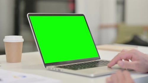 Middle Aged Man using Laptop with Green Chroma Screen