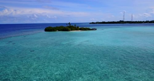 Tropical drone travel shot of a sandy white paradise beach and aqua blue water background in 4K
