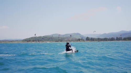 Kitesurfer Glides Across Turquoise Waters on Sunny Day