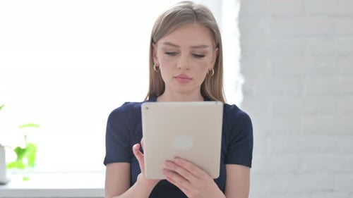 Portrait of Woman Using Tablet in Office