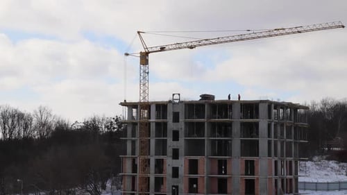 Construction site with big tower crane in time lapse with cloudscape.