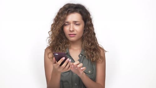 Attractive Young Woman Feeling Upset Using Mobile Phone Finding Unpleasant Information Isolated on