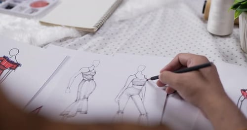 Close up hand of fashion designer man draws a sketch clothing