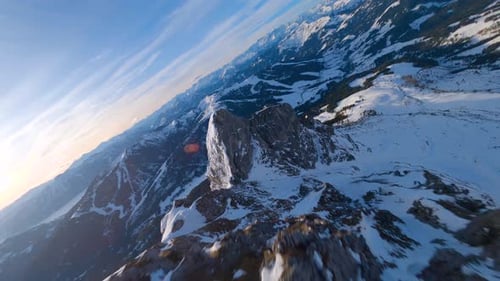 epic winter mountain ridge with summit cross filmed by an fpv drone