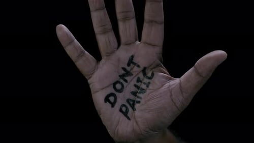 Hand with message against black background