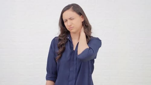 Woman Massaging Her Aching Neck in Studio